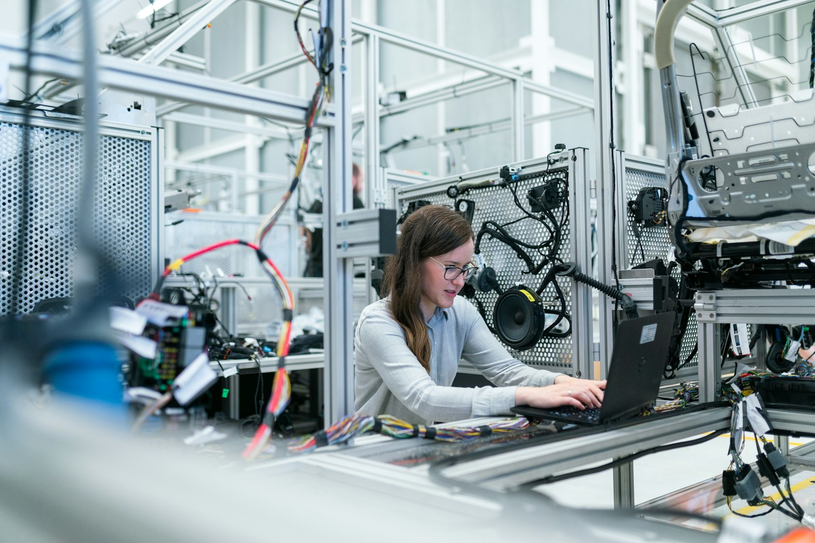 An engineer working on a laptop on a factory floor