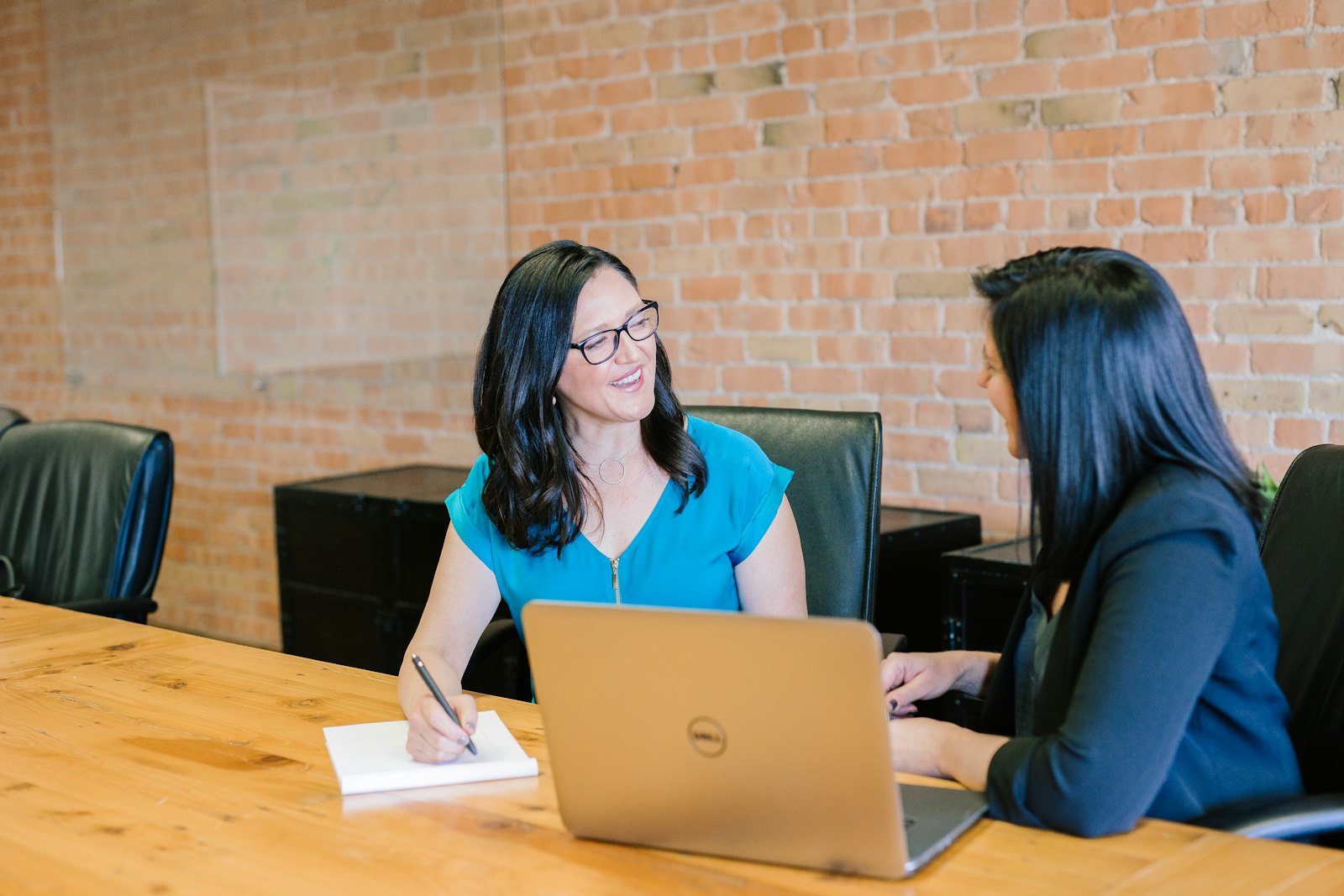 A manager and an employee talking across a desk