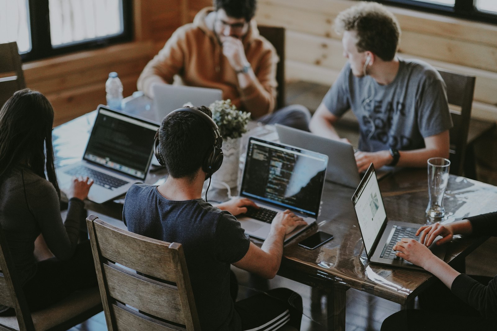 A small startup team working on laptops around one table